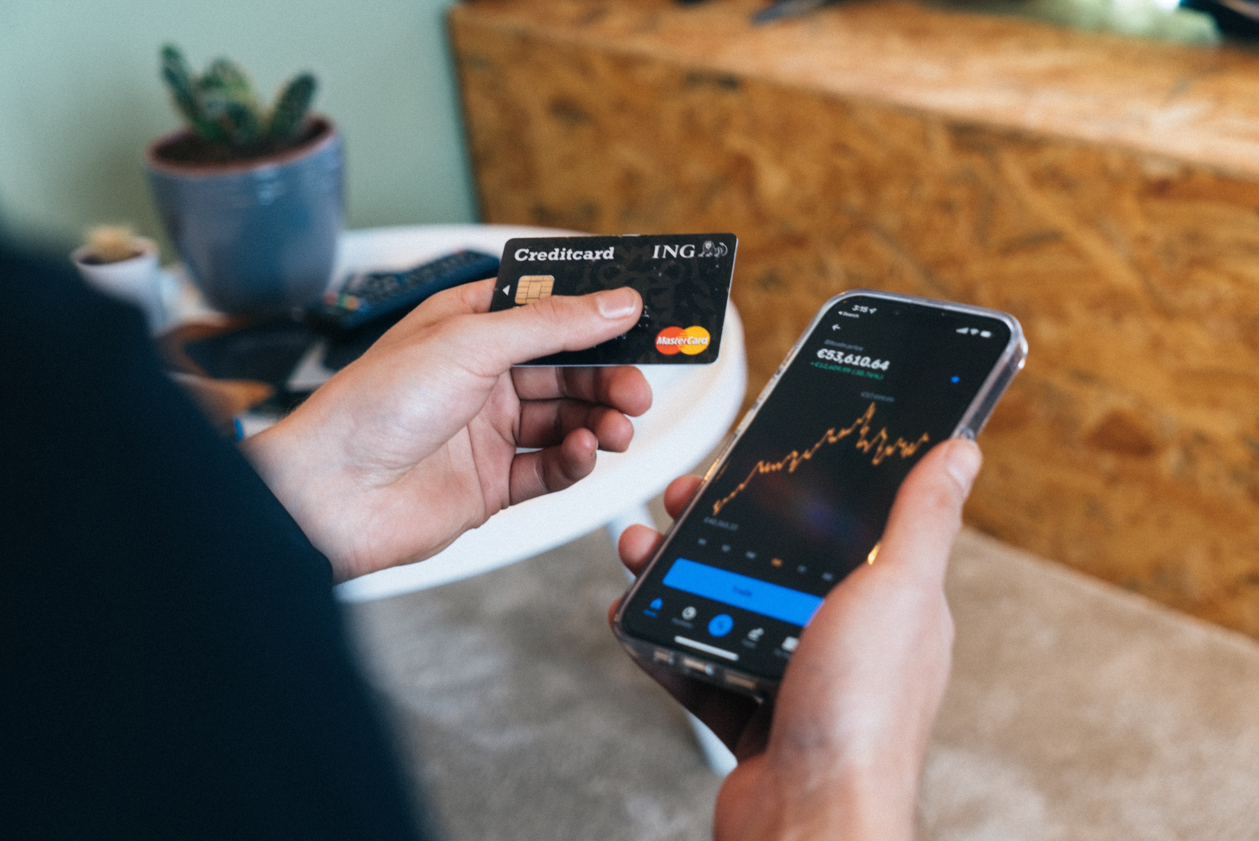 Image of a person using their credit card and opening a wallet app on their phone.